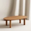 Oval Wooden Coffee Table with rounded edges and natural wood finish.
